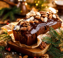 Gingerbread Cake, Christmas Gingerbread Cake Covered With Chocolate And Decorated With Nuts And Almonds On The Holiday Table. Christmas, Traditional Dessert