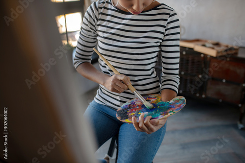 Fotomural Young promising artist mixing gouache while painting