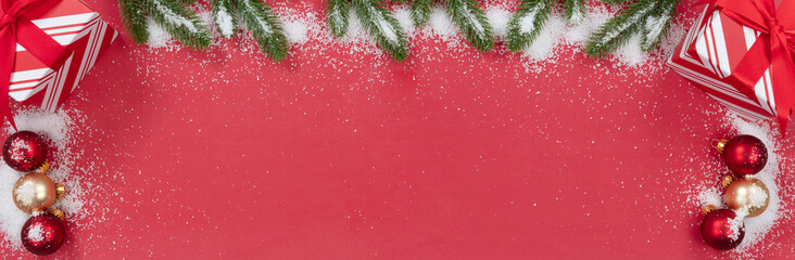 Wall Mural - Christmas decorations on bright red background with snow