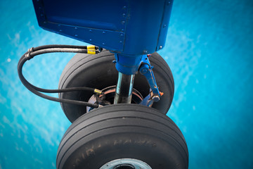 airplane landing gear over ocean