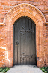 Wall Mural - Black wooden door on a church