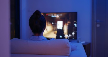 Wall Mural - Woman play video game on tv at home in the evening