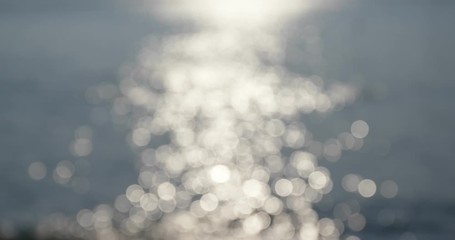 Wall Mural - blur of sea wave with sunlight sparkle