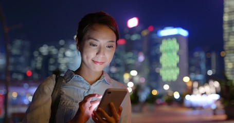 Sticker - Woman use of smart phone in Hong Kong city at night