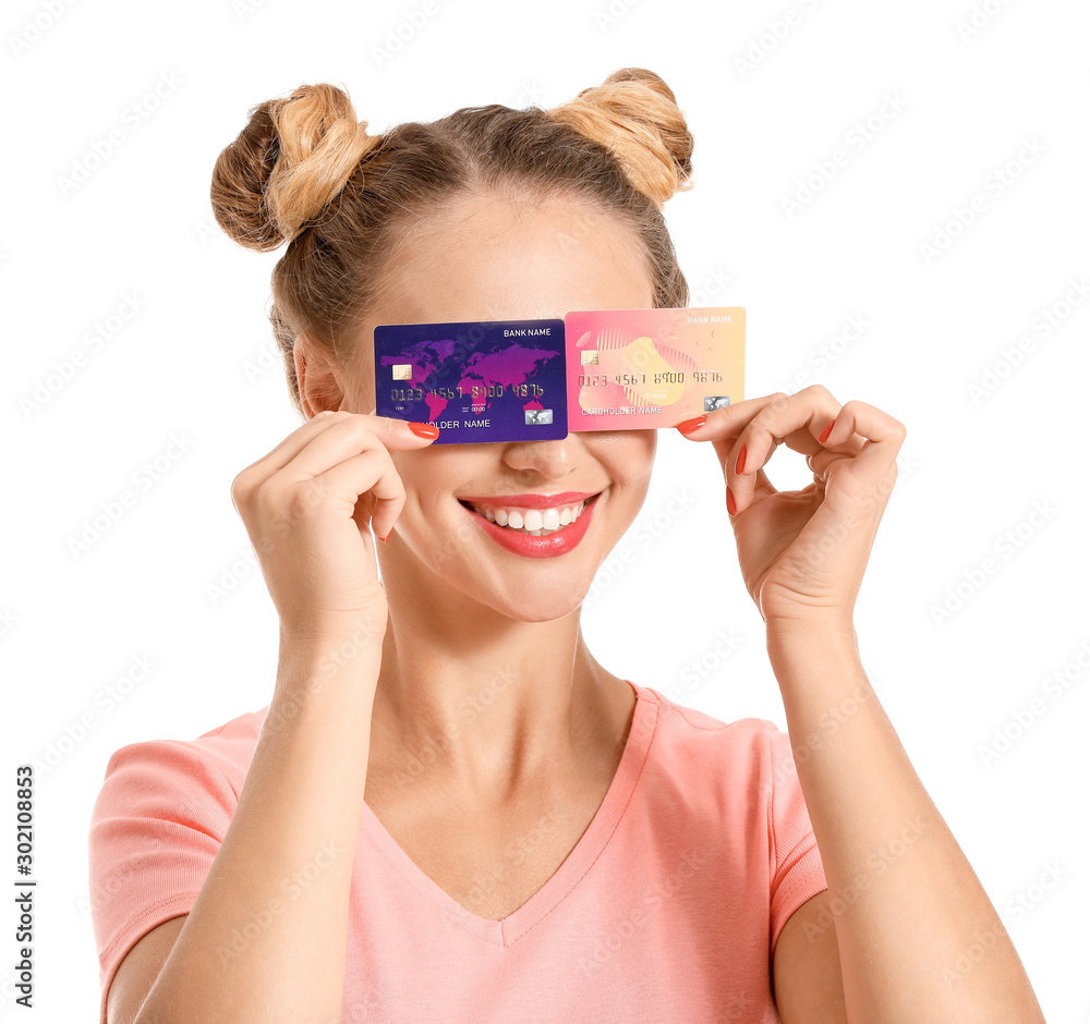 Young woman with credit cards on white background