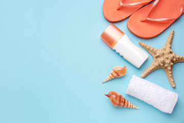 Composition with beach accessories on color background