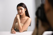 © Shutter B - Beautiful young asian woman and professional makeup artists applies eye shadow. Beautiful woman face. Perfect makeup.