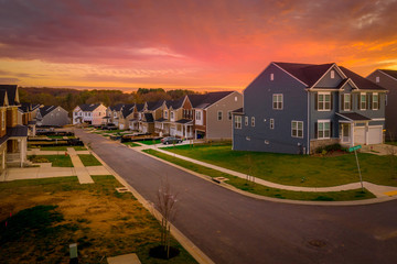 American single family home street with stunning red, orange sunset view