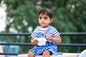 Wall Mural - cute Indian baby girl playing at home