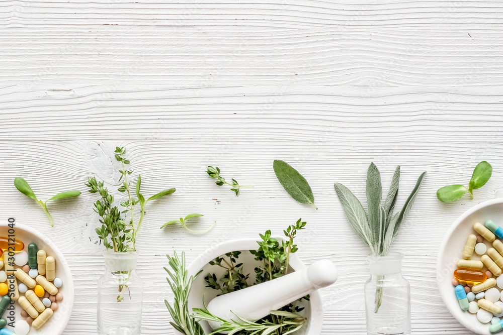 Apothecary of natural wellness and self-care. Herbs and medicine on white wooden background top view frame copy space - obrazy, fototapety, plakaty 