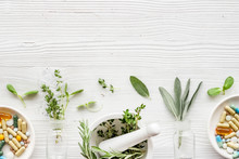 Apothecary Of Natural Wellness And Self-care. Herbs And Medicine On White Wooden Background Top View Frame Copy Space