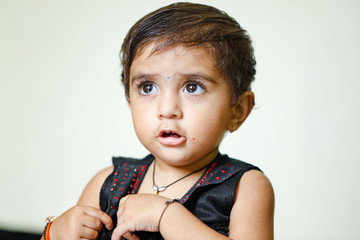 Sticker - cute Indian baby girl playing at home and showing multi pal expression