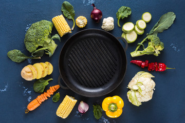 Empty grill pan with fresh vegetarian various ingredients for cooking vegan grilled food overhead view