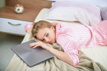 Wall Mural - sleepy girl with laptop