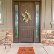 Square Flower wreath on a brown front door with sidelights and windows on both sides