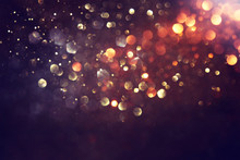 Background Of Abstract Glitter Lights. Gold And Black. De Focused