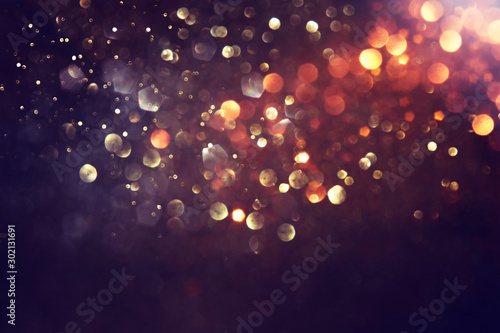 Fotografía background of abstract glitter lights. gold and black. de focused
