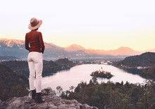Traveling Young Woman Looking At Bled Lake, Slovenia, Europe