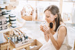 © nataliaderiabina - Woman with personal hygiene items in zero waste shop.