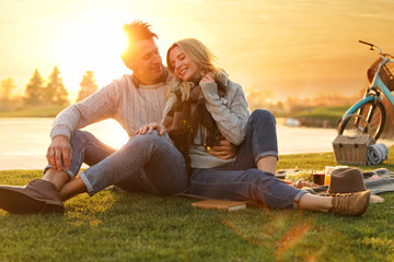 Happy young couple spending time together on picnic outdoors