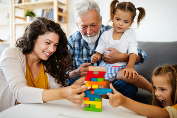 Wall Mural - Happy family playing together and having fun at home