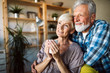 © NDABCREATIVITY - Happy romantic senior couple hugging and enjoying retirement at home