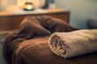 © Natalie - Massage table with f towel and candle in a room, spa