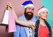 © be free - Buy gifts. Happy new year. Family shopping. Join celebration. Prepare presents in advance. Merry christmas. Man and woman shopping. Christmas shopping. Cheerful couple Santa hats hold paper bags