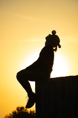 Wall Mural - Silhouette of juggler with balls on colorful sunset