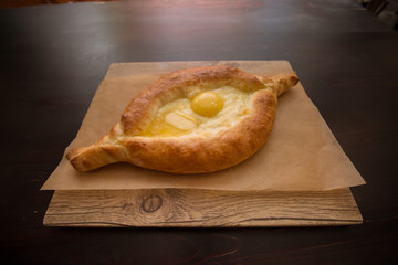 Khachapuri on a dish in a restaurant. Caucasian dish.