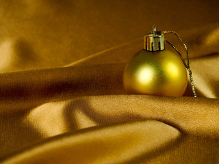 Canvas Print - Christmas decoration on gold background, Golden balls and silk fabric. Christmas card, space for text. The decor for the new year yellow