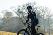 © Mountains Hunter - Cyclist in pants and fleece jacket on a modern carbon hardtail bike with an air suspension fork rides off-road.