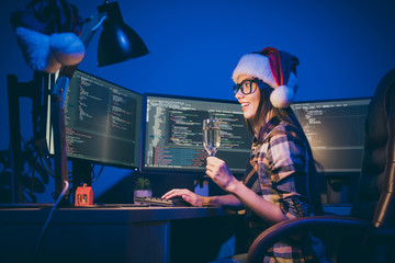 Profile photo of programmer lady with sparkling wine glass watching screen reading greeting sms work late night meet newyear alone office workaholic wear santa cap glasses indoors