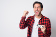 © Ranta Images - Portrait of happy Hispanic hipster man playing games and winning