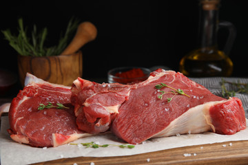 Fresh raw beef cut on wooden table, closeup