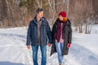 © Tatyana_Andreyeva - Handsome man and attractive young woman walking along snowy country road in sunny day. Beautiful look, male and female fashion, winter outfit. Winter holidays, weekend at countryside concept