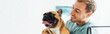 © LIGHTFIELD STUDIOS - Panoramic shot of smiling man holding french bulldog