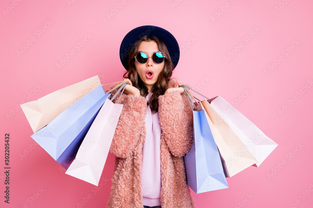 Photo of pretty millennial lady carry many packs shopper tourism abroad look unbelievable sales low prices mall wear fluffy jacket sun specs blue hat isolated pink background - obrazy, fototapety, plakaty 