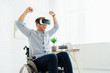 © LIGHTFIELD STUDIOS - Cheerful man in wheelchair using virtual reality headset in living room