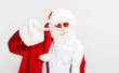 © Prostock-studio - Cheerful Santa smiling and showing v sign on white