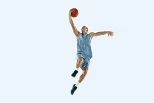High Flight. Young Caucasian Basketball Player Of Team In Action, Motion In Jump Isolated On White Background. Concept Of Sport, Movement, Energy And Dynamic, Healthy Lifestyle. Training, Practicing.