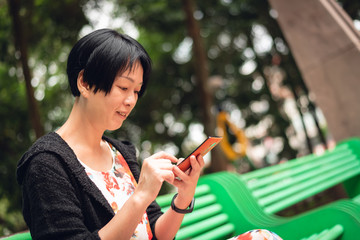 Wall Mural - woman sitting and using cellphone