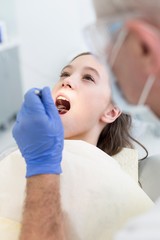 Doctor cleaning or pulling patient teeth in clinic