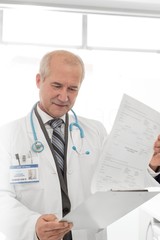 Doctor reading medical results in clinic