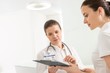 © MDBPIXS - Doctor reading medical result of patient in clinic