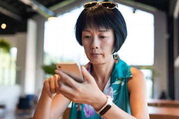 Poster - woman using smartphone in a coffee shop