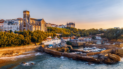 Wall Mural - Panoramic view of Biarritz cityscape, coastline with its famous sand beaches and port for small boats. Golden hour. Aquitaine, France.