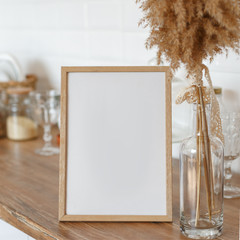 Wooden frame on the kitchen table in the interior.