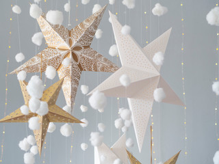 Still life Christmas studio background with a 3d stars and fluffy cotton clouds on a light gray background. Kids room decoration