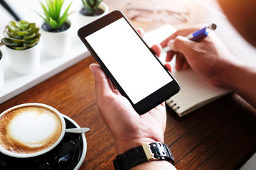 Cropped shot view of business woman’s hands holding the mobile phone with blank copy space screen for your information content or text message, the woman reading text message on the smart phone .